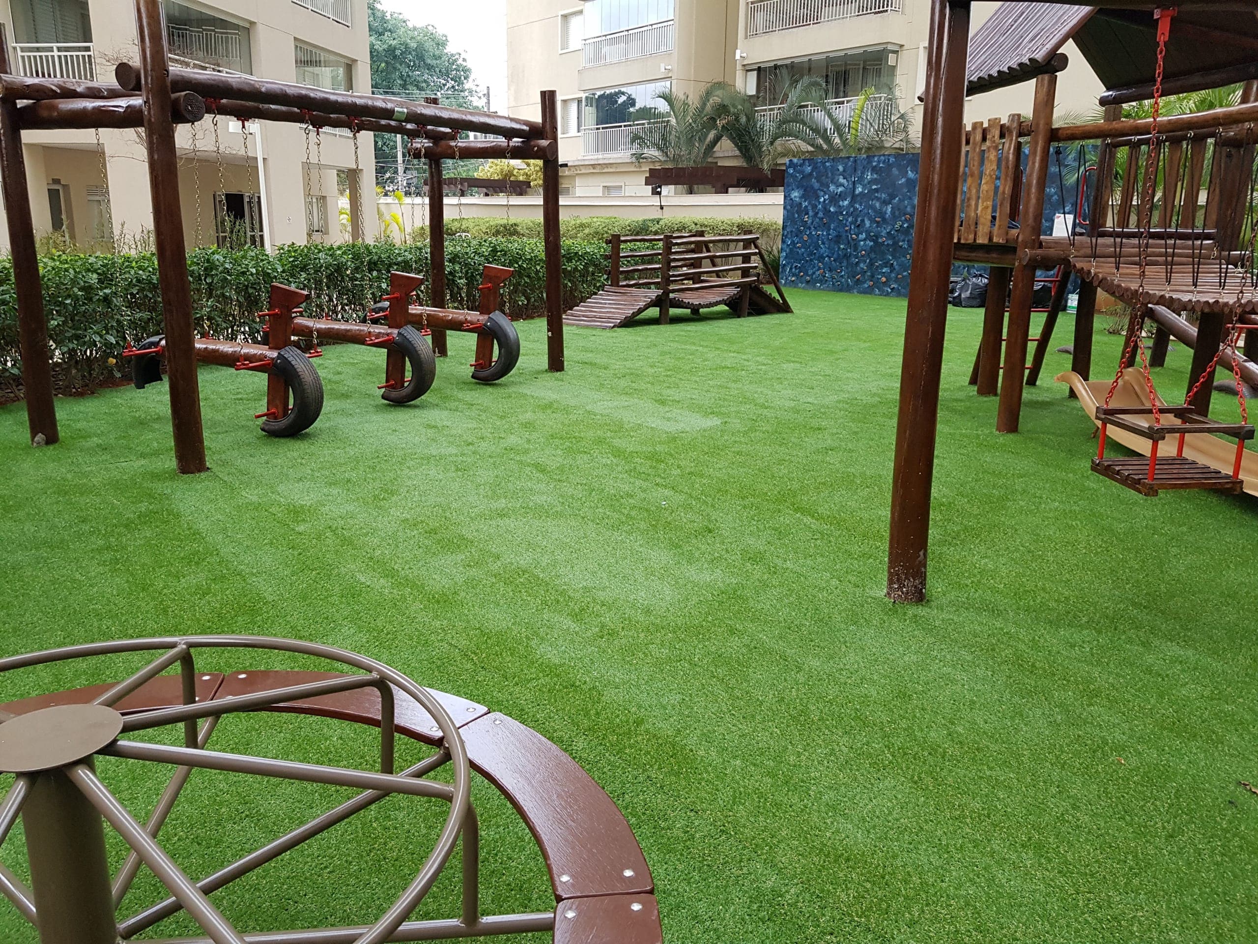 Playground de condomínio com grama sintética instalada